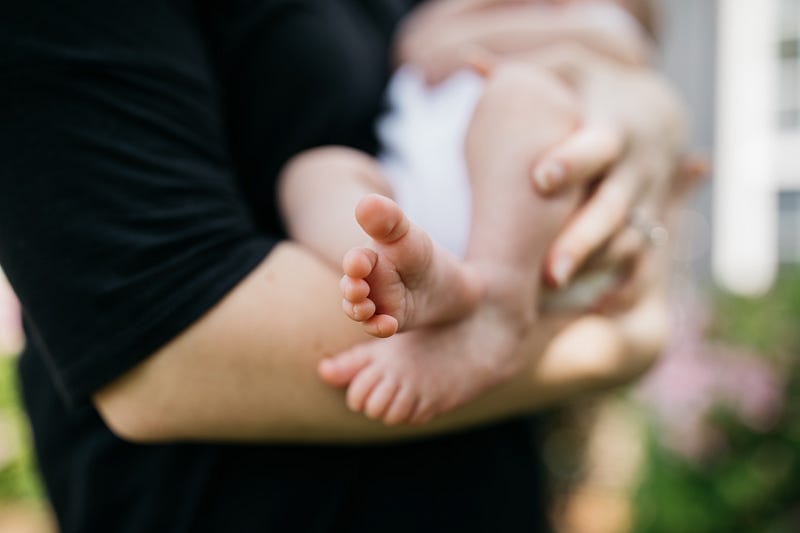 Mother breastfeeding child, showcasing early dietary influence