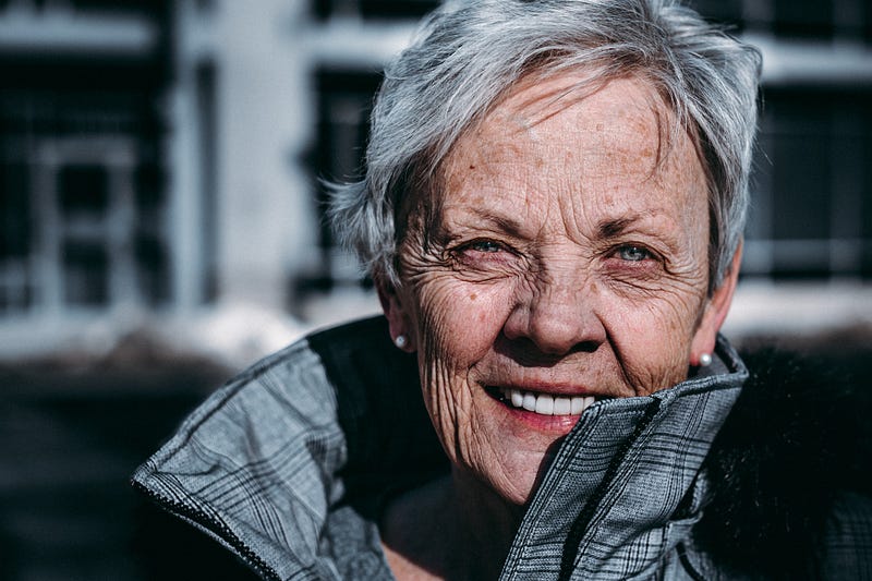 A determined older woman engaging with her laptop